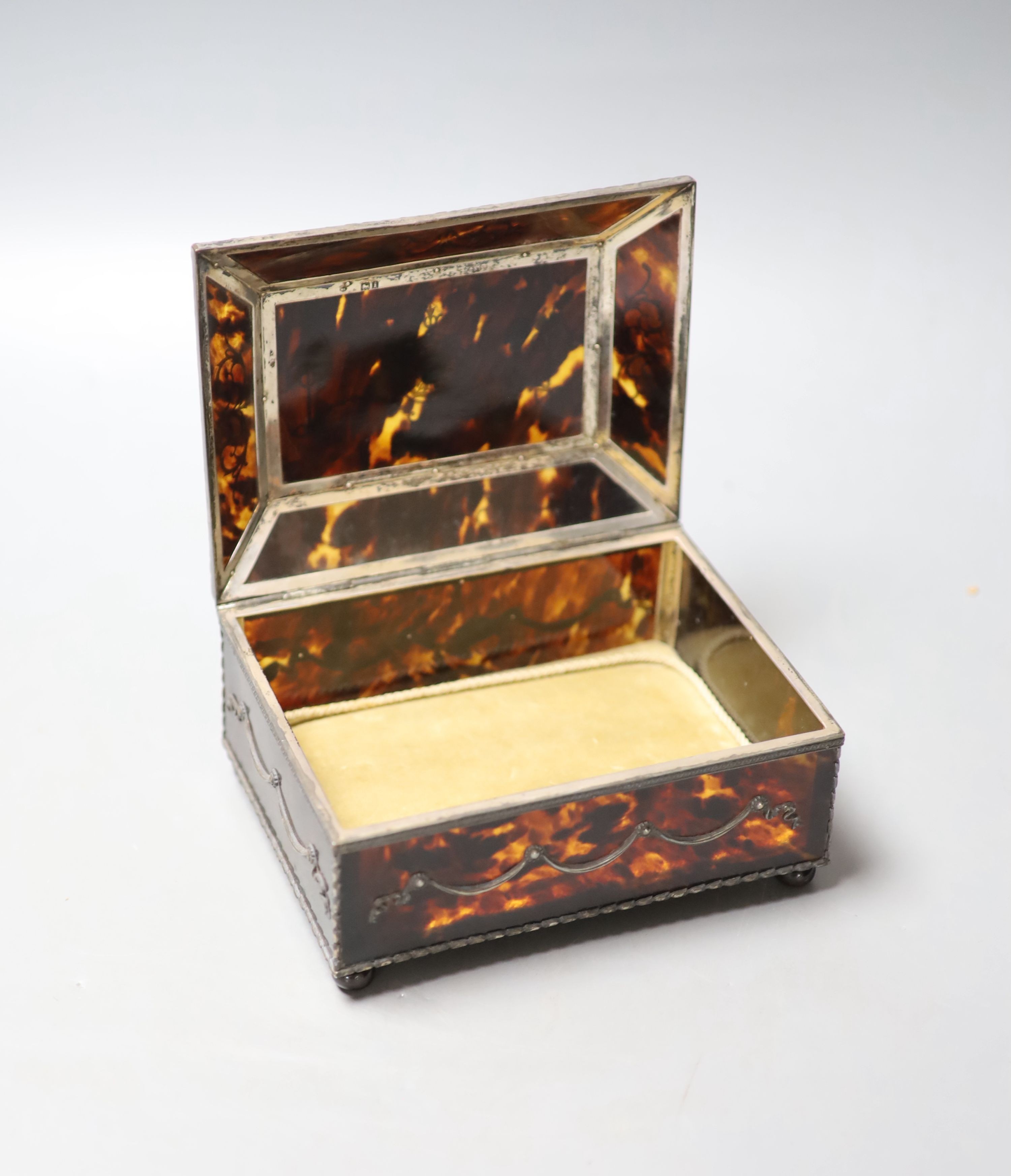 A silver-mounted tortoiseshell pique rectangular trinket box, by William Comyns, raised on four ball feet, London, 1904, width 15cm. 15cm